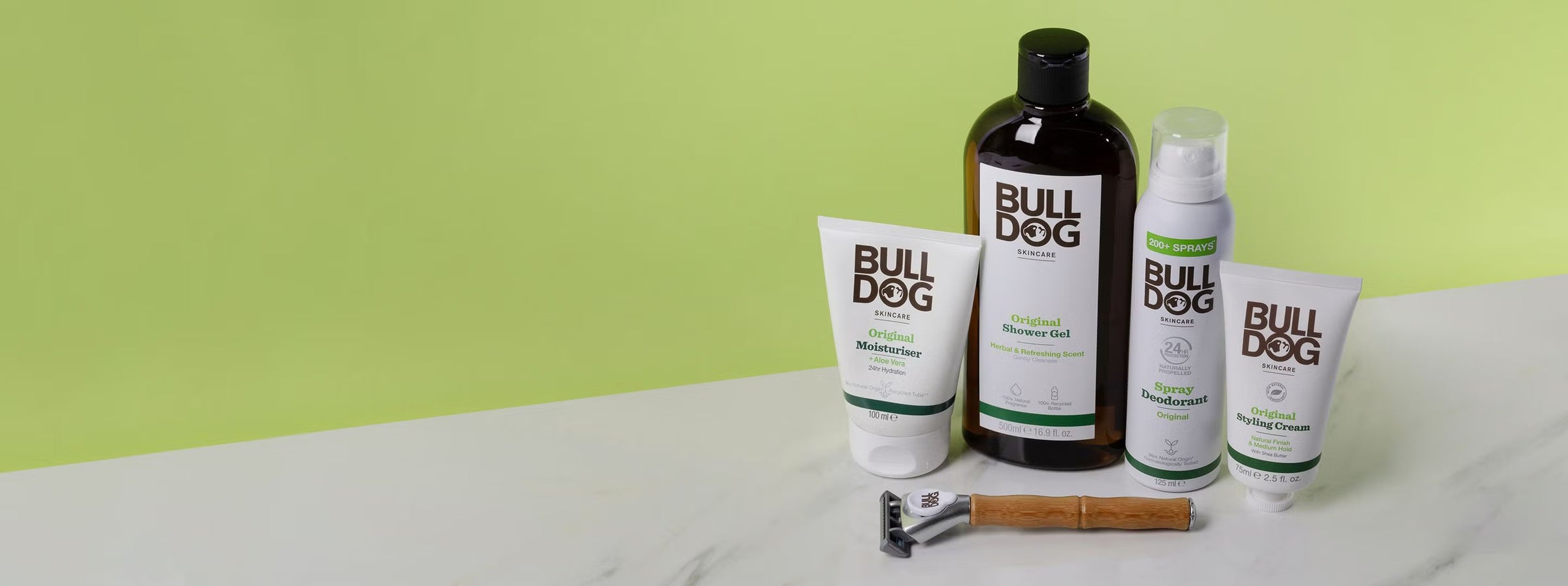 Bulldog grooming products including a bottle, tube, and cream on a light surface with a green background