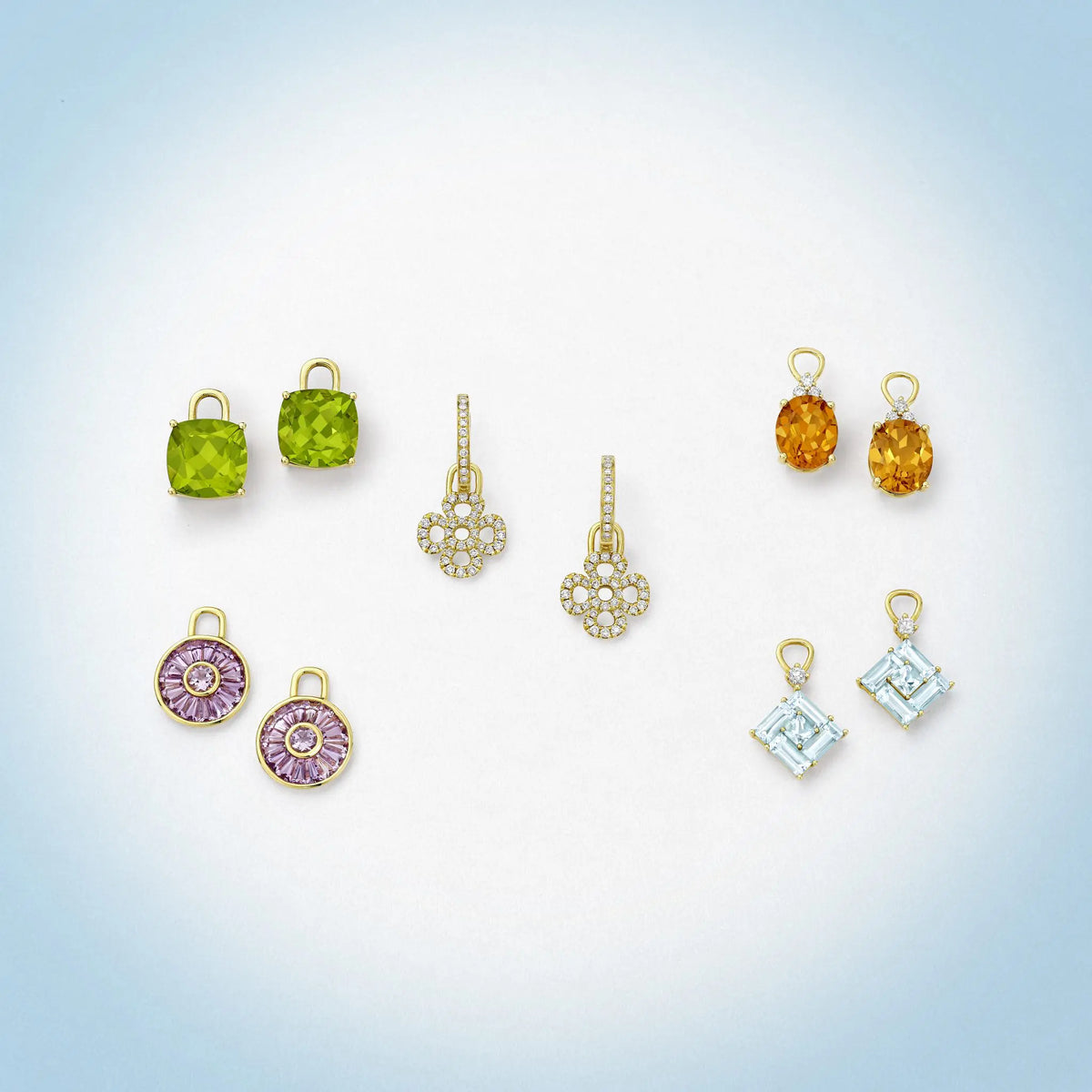 Collection of various gemstone earrings on a gradient background