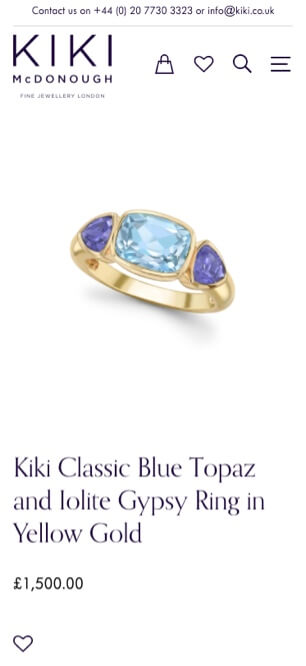 Kiki McDonough ring with blue topaz and iolite in yellow gold on a white background