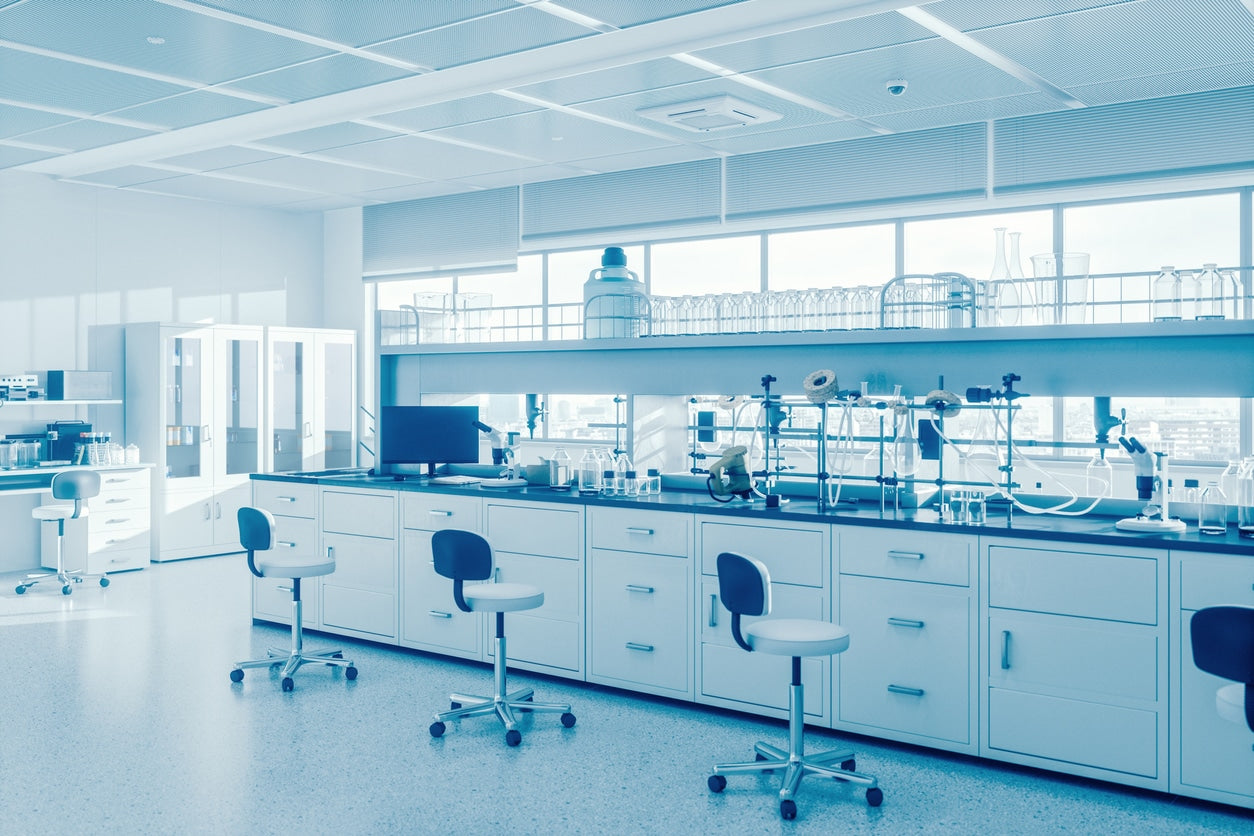 Modern laboratory with white cabinets, chairs, and equipment.