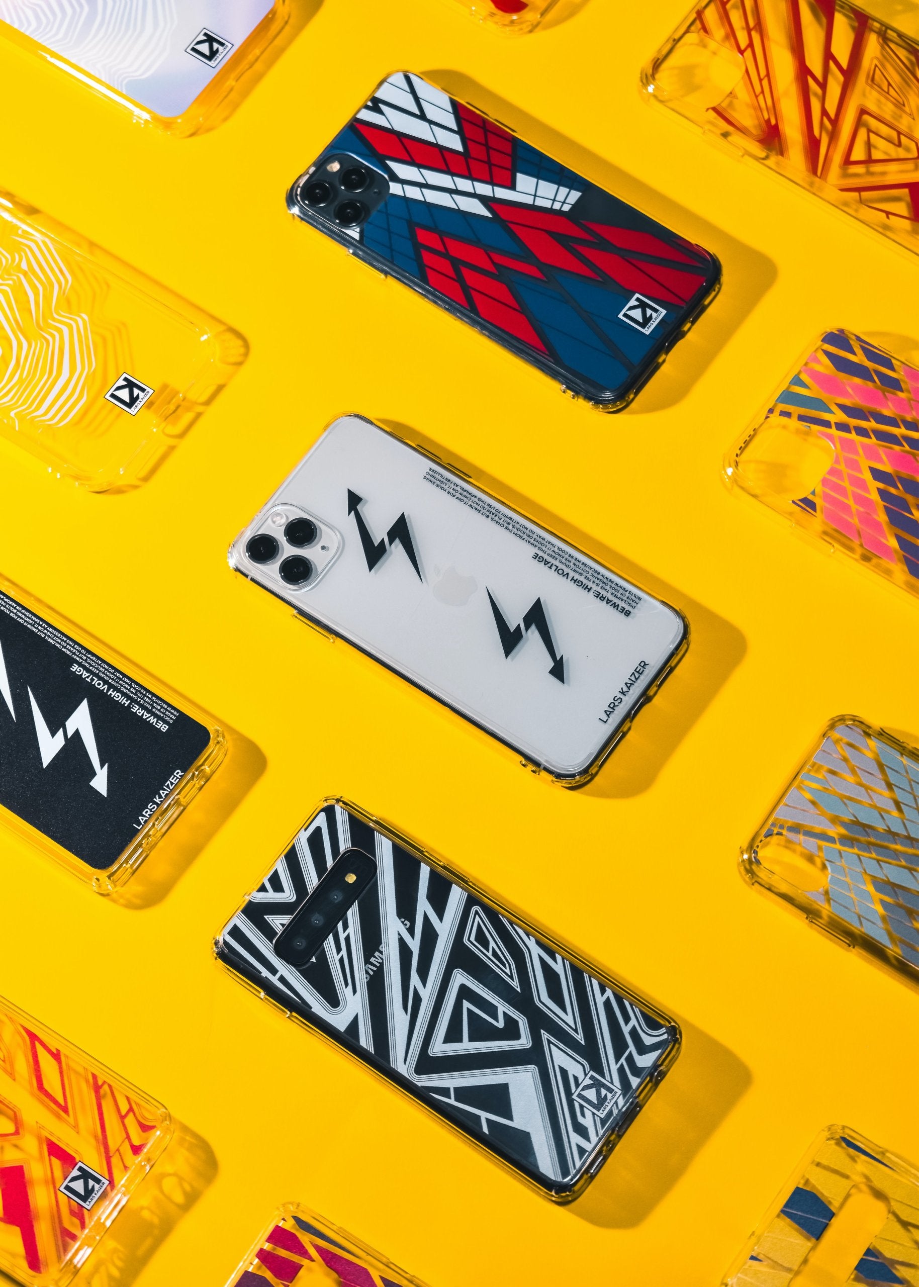 Phone cases with geometric designs on a yellow background