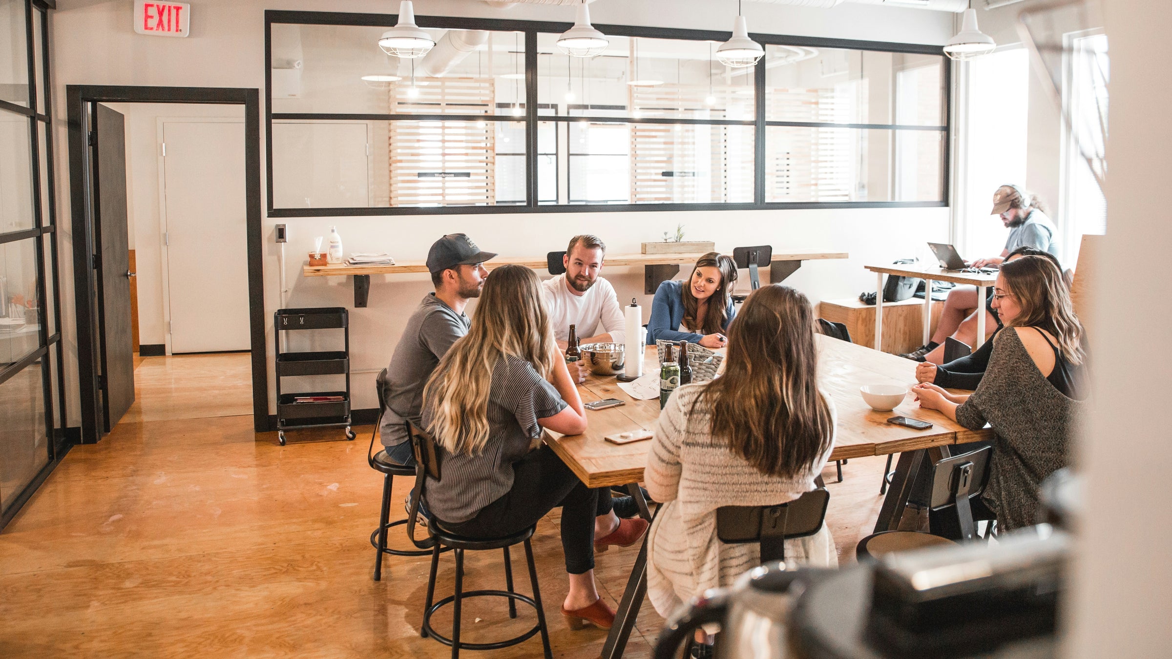 Group of people sitting around a table in a modern office setting