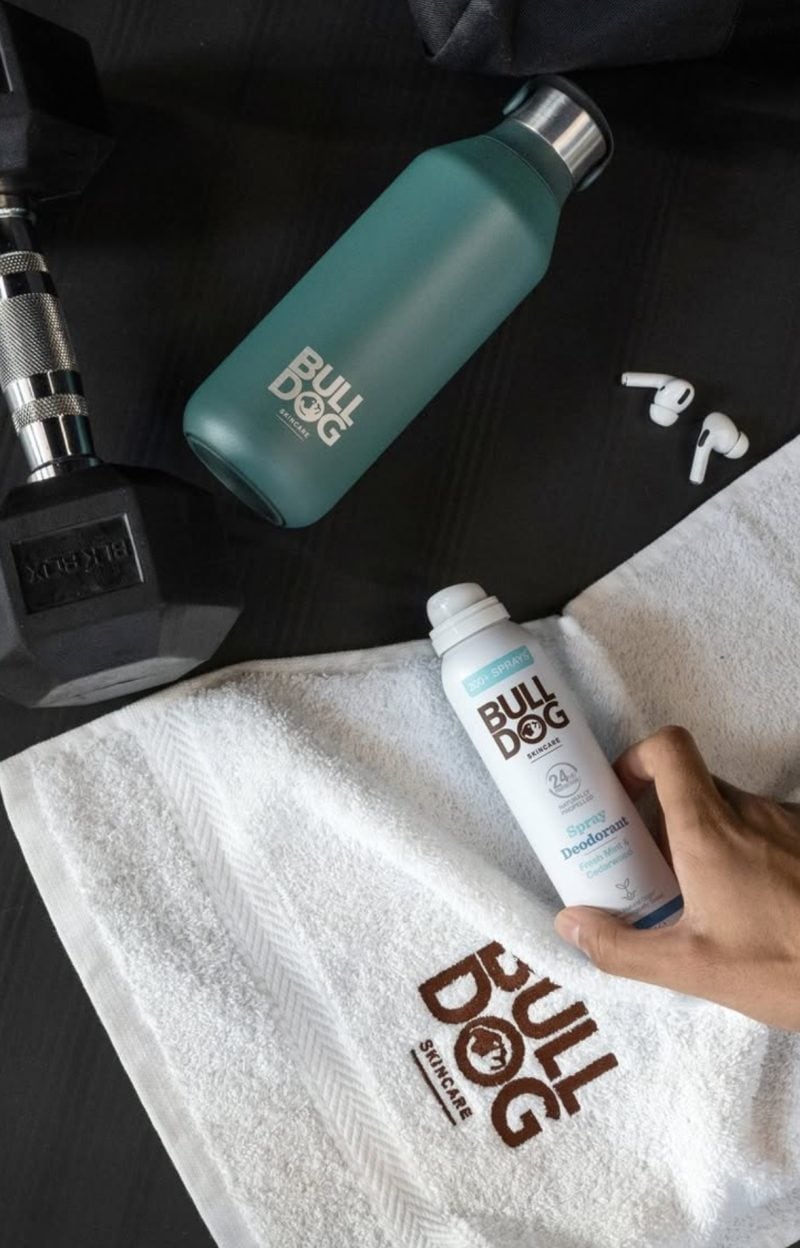 Bulldog Skincare Fitness Image featuring spray deodorant, earphones, a weight and water bottle